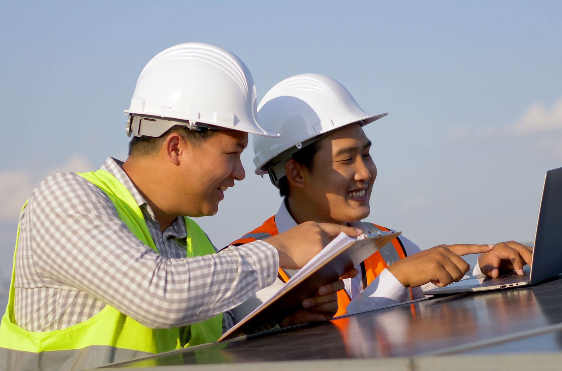 Asian Electrical Engineer Checking Position Using Notebook Computer